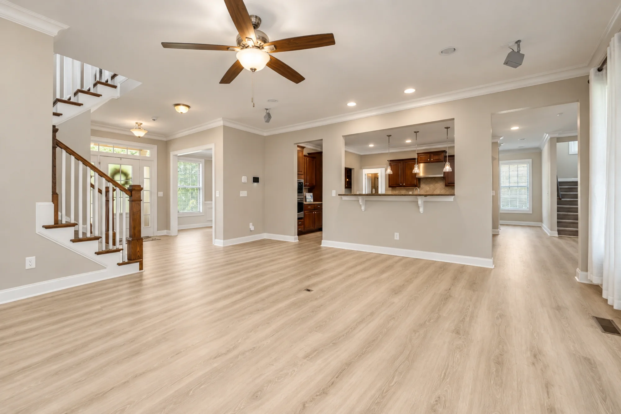 TrueLevel installer fitting dark wood-look flooring in a home